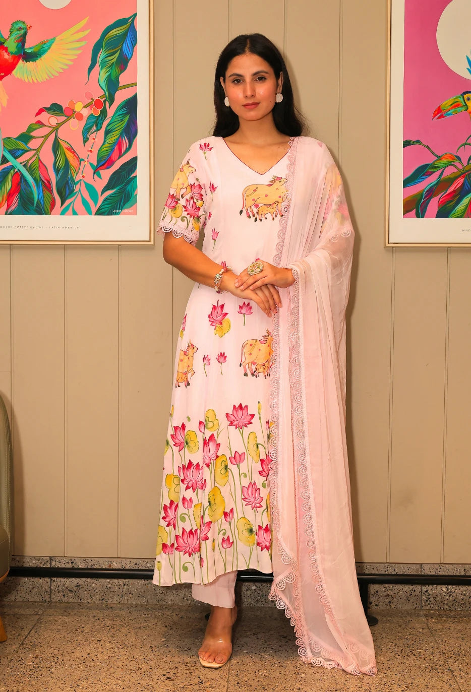 Lotus Reverie from Destiny by Anjali, a stunning designer traditional suit crafted from soft cotton. This baby pink ensemble features beautiful hand-painted lotus flowers that add a touch of elegance and charm. Fully lined and designed for all-weather comfort, this piece is a trending choice for occasion wear. Whether attending a festive celebration or a casual gathering, this suit is perfect for all occasions, seamlessly blending traditional artistry with modern style.