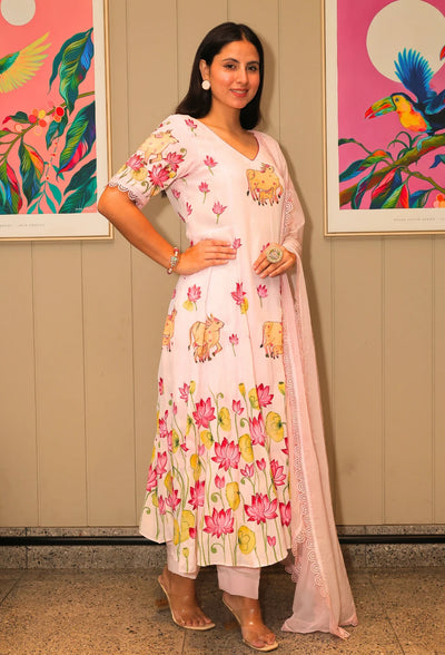 Lotus Reverie from Destiny by Anjali, a stunning designer traditional suit crafted from soft cotton. This baby pink ensemble features beautiful hand-painted lotus flowers that add a touch of elegance and charm. Fully lined and designed for all-weather comfort, this piece is a trending choice for occasion wear. Whether attending a festive celebration or a casual gathering, this suit is perfect for all occasions, seamlessly blending traditional artistry with modern style.