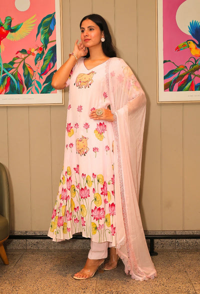 Lotus Reverie from Destiny by Anjali, a stunning designer traditional suit crafted from soft cotton. This baby pink ensemble features beautiful hand-painted lotus flowers that add a touch of elegance and charm. Fully lined and designed for all-weather comfort, this piece is a trending choice for occasion wear. Whether attending a festive celebration or a casual gathering, this suit is perfect for all occasions, seamlessly blending traditional artistry with modern style.