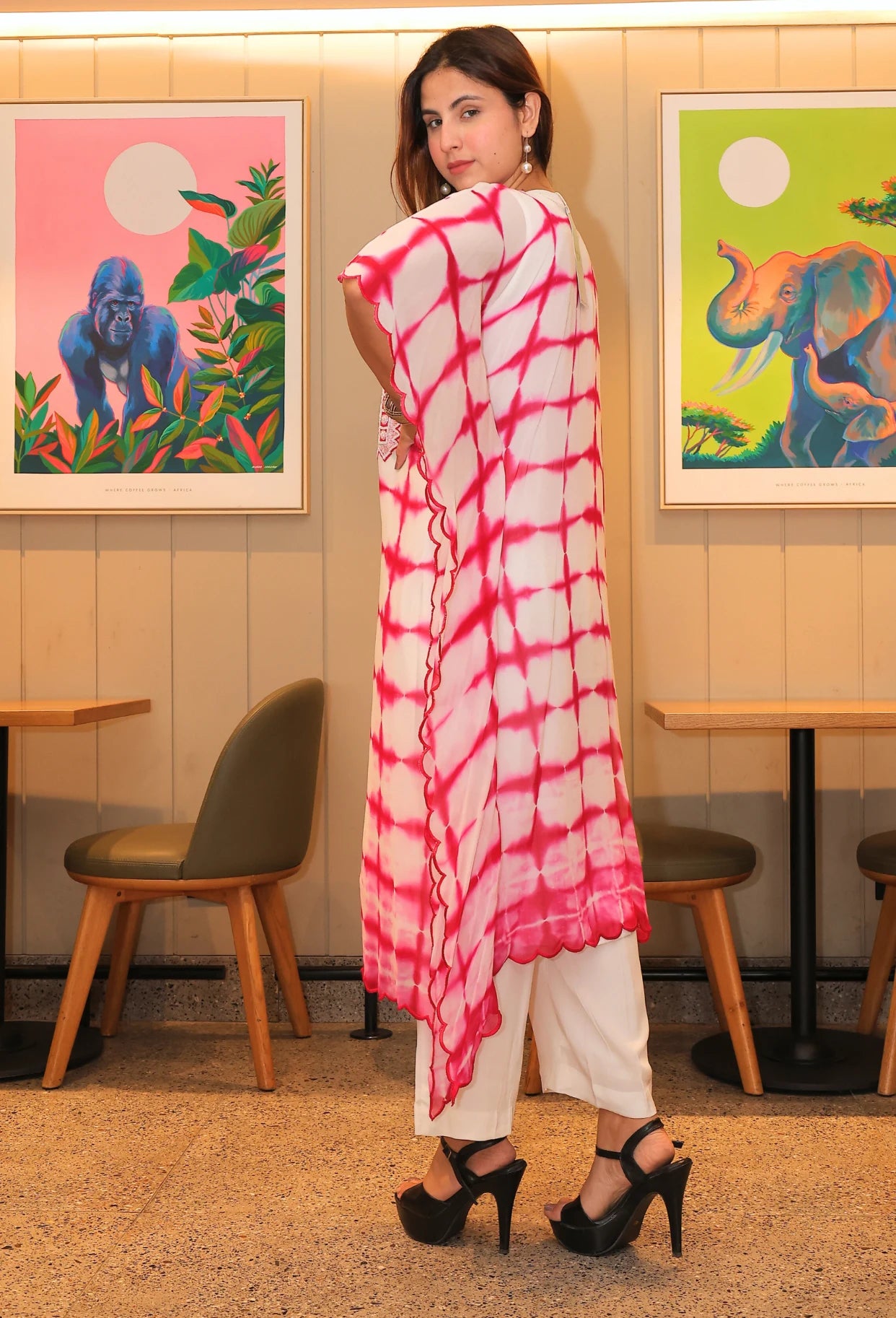 the Deli Dye Dream kaftan - a fusion of bohemian tie dye and elegant hand embroidery. Made with pure georgette fabric, this one-sided kaftan is perfect for breezy summer days. Its box styles add a touch of sophistication as you walk in style and make a statement. The dress comes with one inner and white straight fit cotton pants.