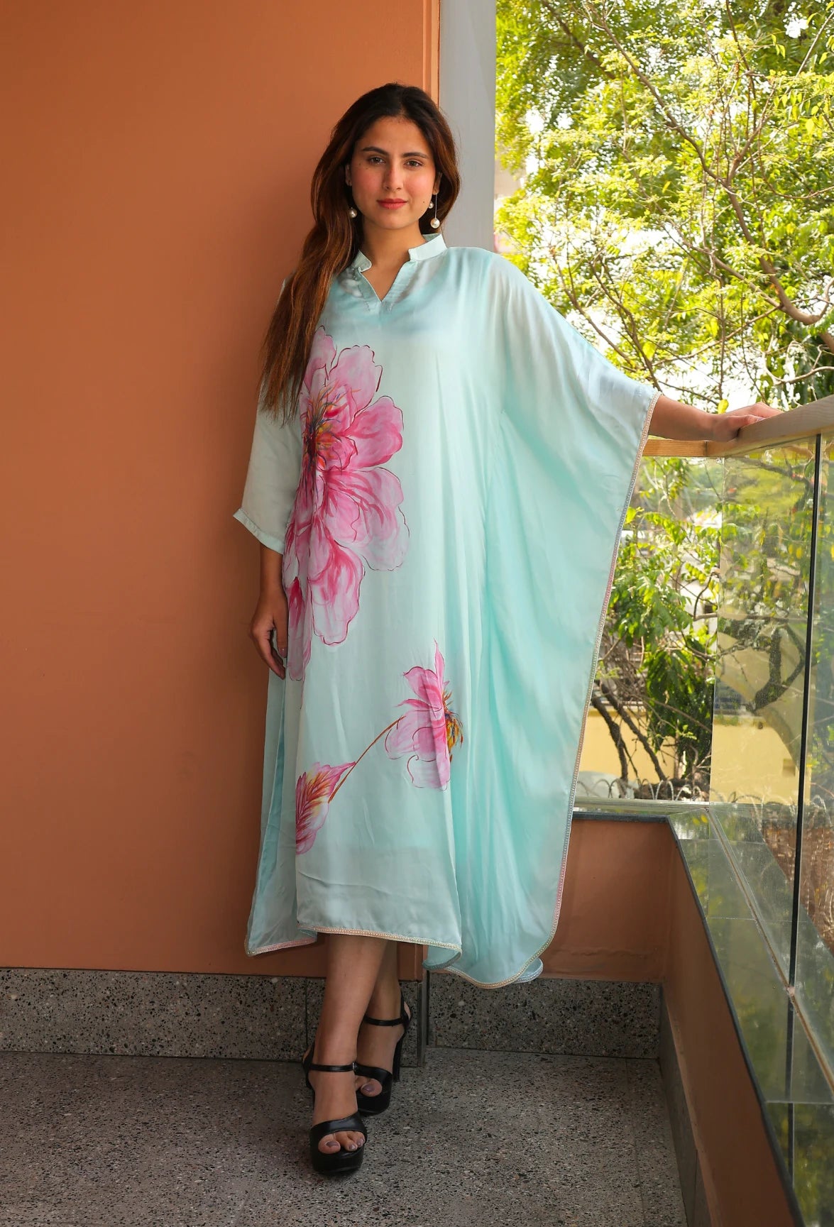 Indulge in the beauty of Pink Blossom, a hand-painted floral kaftan by designer brand, Destiny by Anjal. Made with luxurious modal satin, its cool sea green color evokes a sense of summer breeze. This trendy and new arrival piece will elevate your summer wardrobe. the kaftan comes with an comfortable inner to compensate the see through modal satin fabric.