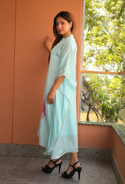 Indulge in the beauty of Pink Blossom, a hand-painted floral kaftan by designer brand, Destiny by Anjal. Made with luxurious modal satin, its cool sea green color evokes a sense of summer breeze. This trendy and new arrival piece will elevate your summer wardrobe. the kaftan comes with an comfortable inner to compensate the see through modal satin fabric.