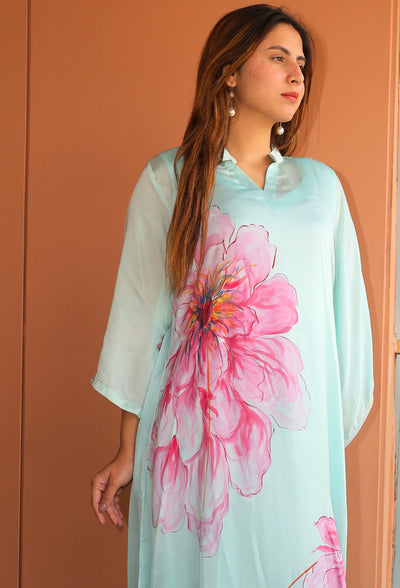 Indulge in the beauty of Pink Blossom, a hand-painted floral kaftan by designer brand, Destiny by Anjal. Made with luxurious modal satin, its cool sea green color evokes a sense of summer breeze. This trendy and new arrival piece will elevate your summer wardrobe. the kaftan comes with an comfortable inner to compensate the see through modal satin fabric.