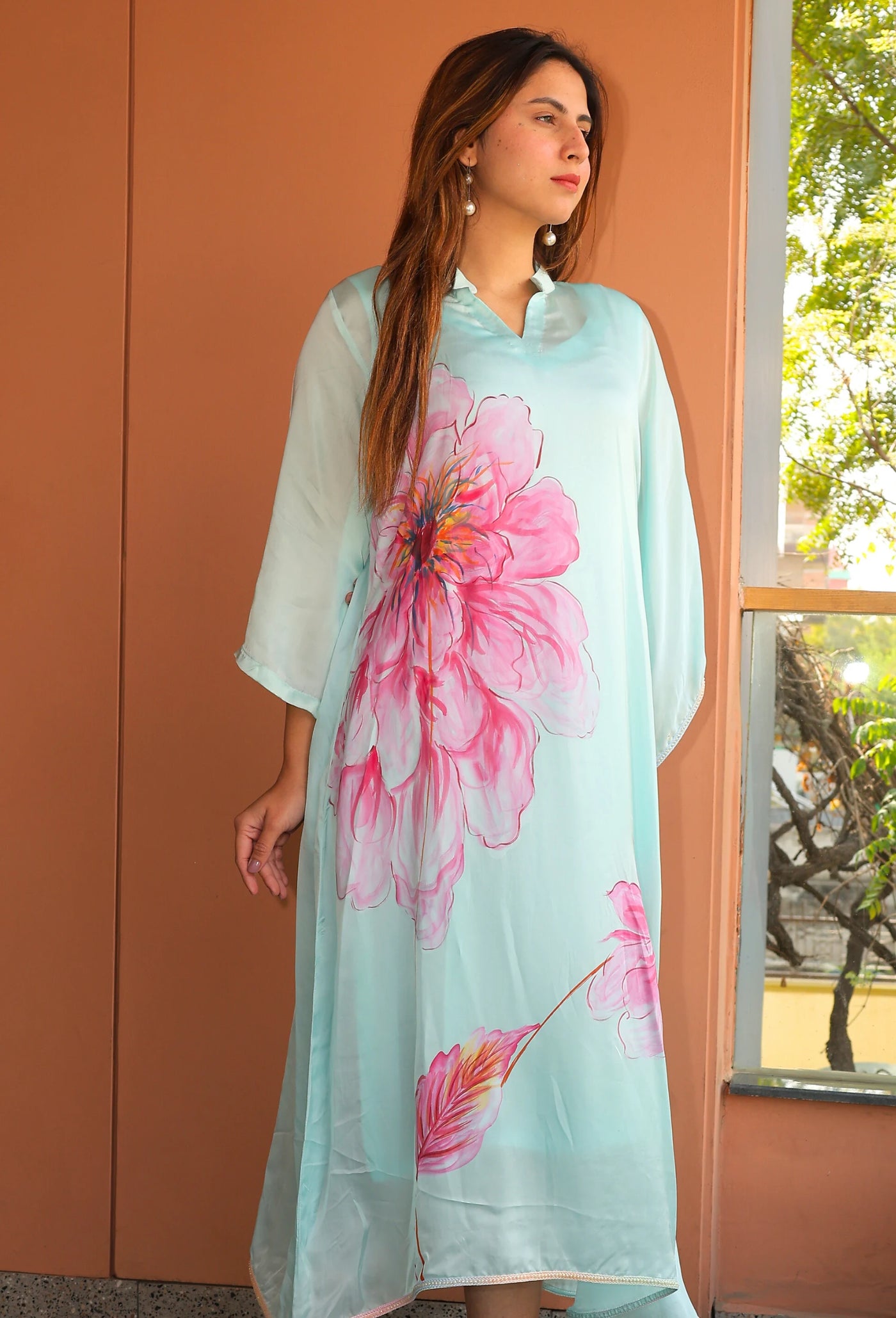 Indulge in the beauty of Pink Blossom, a hand-painted floral kaftan by designer brand, Destiny by Anjal. Made with luxurious modal satin, its cool sea green color evokes a sense of summer breeze. This trendy and new arrival piece will elevate your summer wardrobe. the kaftan comes with an comfortable inner to compensate the see through modal satin fabric.