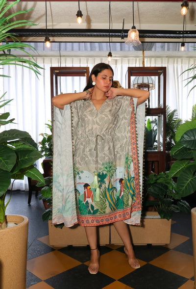 the Oasis Opulence Kaftan from Destiny by Anjali. This designer kaftan in beige and green features a stunning digital print inspired by tribal and beach women. Made from breathable cotton linen fabric, it’s perfect for all-weather wear, keeping you stylish and comfortable. Whether you're lounging at the beach or attending an occasion, this trending Western wear piece is ideal for any event. The kaftan's relaxed fit and intricate print make it a versatile choice for every occasion, blending luxury with comfo