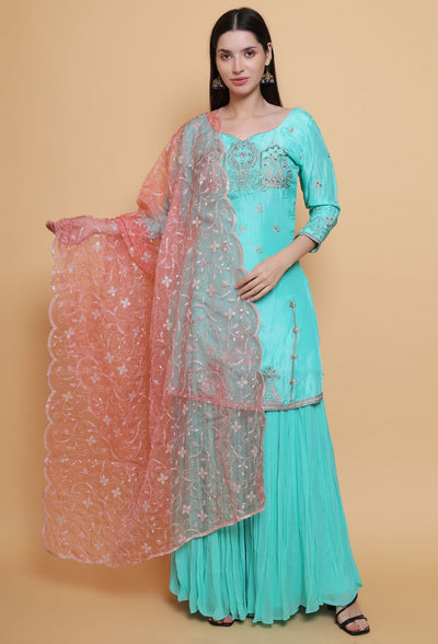 Destiny by Anjali: Tropical Blue Sharara Suit. Embroidered upada silk with Embroidered Pink Net Dupatta. Sharara fashion, designer clothing, unique color.