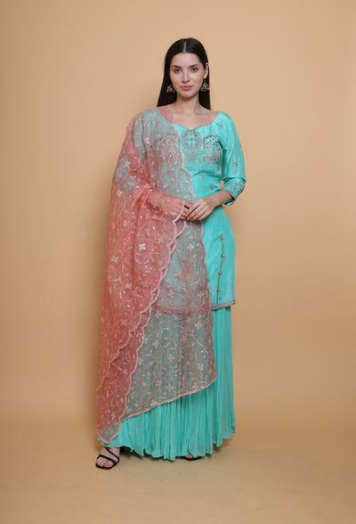 Destiny by Anjali: Tropical Blue Sharara Suit. Embroidered upada silk with Embroidered Pink Net Dupatta. Sharara fashion, designer clothing, unique color.